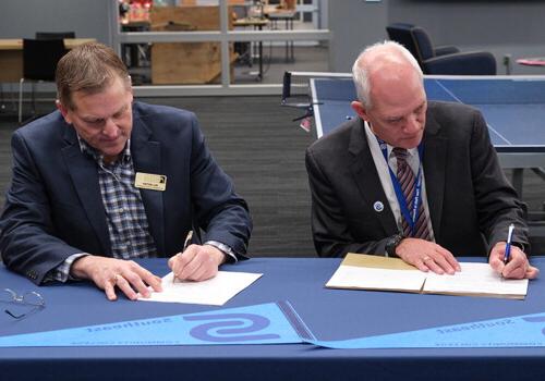 Dr. Paul Illich, SCC president, and Bill Motzer, vice president for enrollment management at NWU, sign the Biotechnology Pathway Agreement.